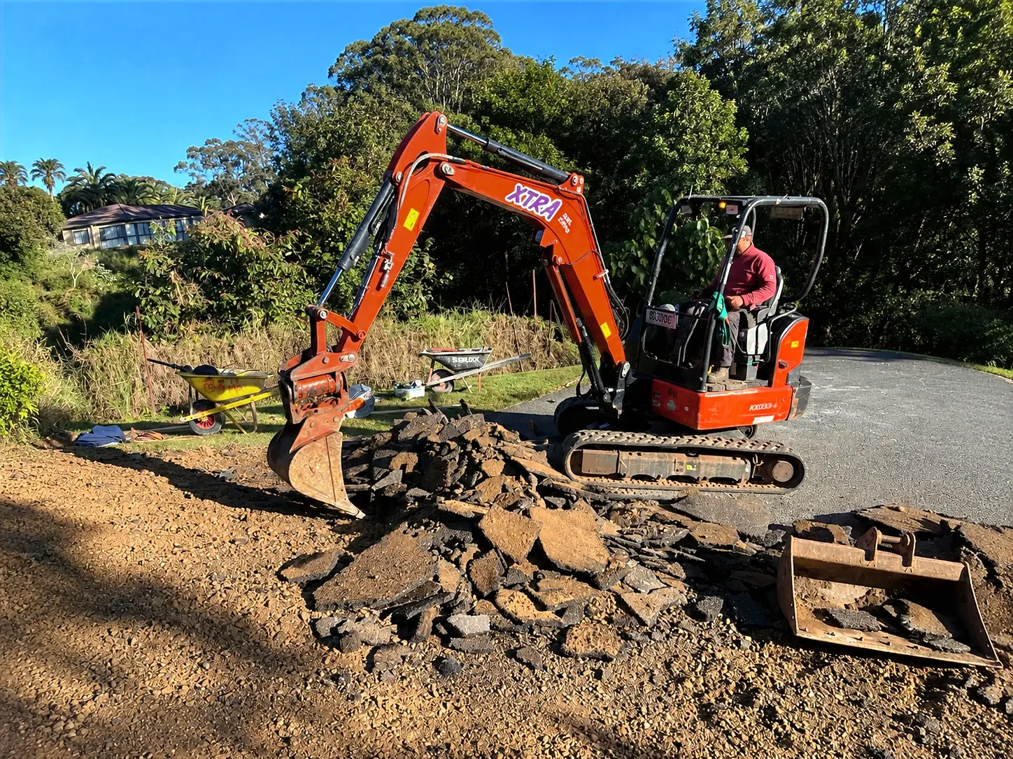 Excavation and removal of existing driveway surface